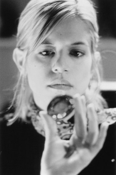 Tammy Lauren as Alex, examining the Djinn's opal [Credit: Live Entertainment)